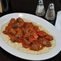 Sultans Delight · Tender lamb pieces over pureed eggplant and Cheddar cheese. Served with rice.