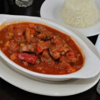 Lamb Stew · Traditional lamb stew with green peas, potatoes and carrots. Served with rice pilaf.