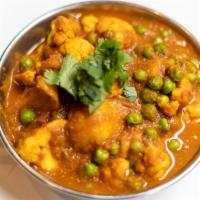 Aloo Gobi Matar · Stir fried cauliflower, baby green pea, potato, garlic, and cumin. Server with basmati rice....