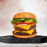 The Trouble With Doubles · Two American beef patties topped with melted cheese, buttered lettuce, tomato, onion, and pi...