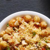 Chole Chaat · Boiled chickpeas tossed with onions, potatoes, tangy & spicy chutney, spices & topped with y...
