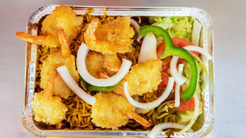 Shrimp Over Rice · Breaded juicy jumbo shrimps fried and served over rice with salad, french fries and sauce.