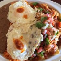 Ground Beef Red Chilaquiles · Your choice of meat, homemade red sauce, queso fresco, pico de gallo and cilantro. Plated wi...