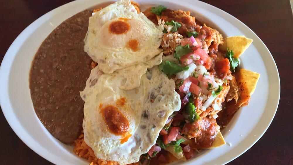 Ground Beef Red Chilaquiles · Your choice of meat, homemade red sauce, queso fresco, pico de gallo and cilantro. Plated with yellow rice and refried pinto beans.