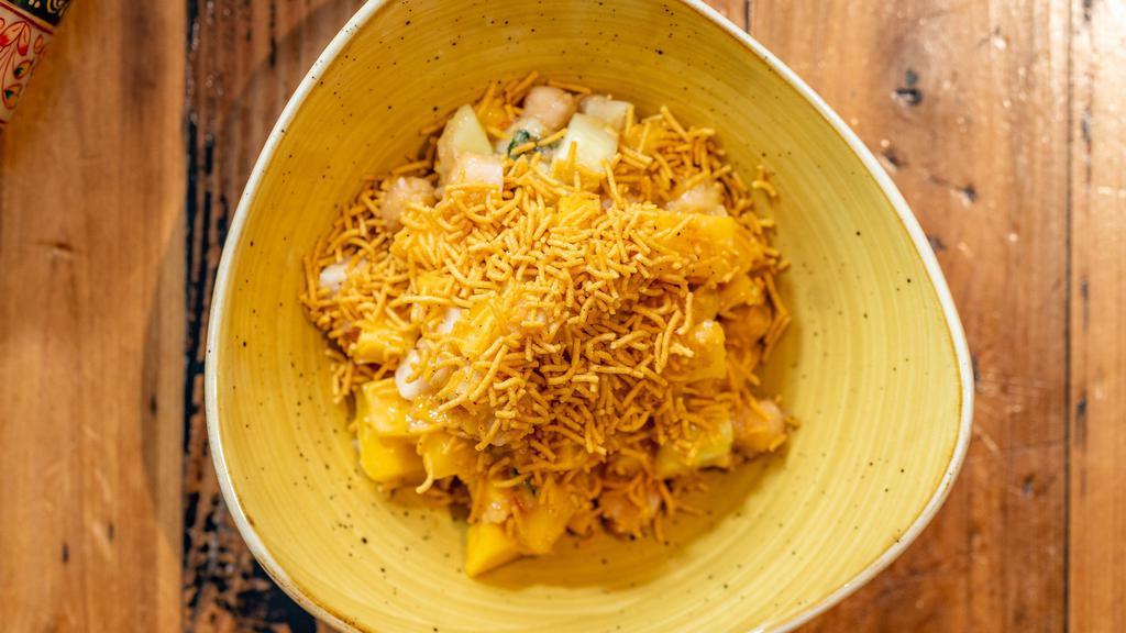 Khatta Meetha Chaat · Vegan, gluten free. Medium heat. Delhi street-style salad with chickpeas, mangoes, cucumbers, crispy potatoes, and devil chutney.