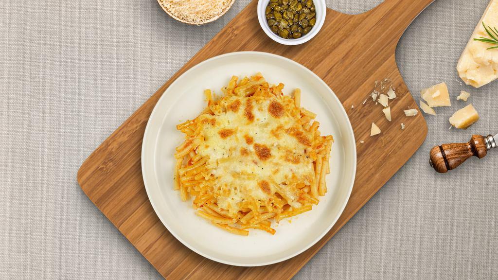 Baked Ziti Buster · Ziti pasta, ground beef, homemade rossa (red) sauce, creamy white sauce, mozzarella cheese, and parmesan baked together until crisp.