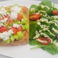 Avacado Toast · Fresh avocado, tomatoes, goat cheese, house made dressing & red flaked pepper on a multigrai...