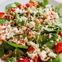 Goat Salad · Spinach, tomatoes, honey, strawberries, walnuts, goat cheese and sauce vinaigrette.