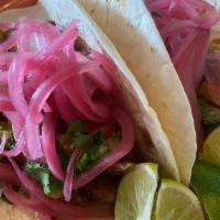 Al Pastor Taco · spit-fired marinated pork, thinly sliced, topped with grilled pineapple, pickled red onions ...