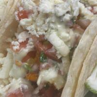Mexi-Hot Fried Chicken Taco · topped with pico de gallo, queso fresco and our avocado-ranch dressing