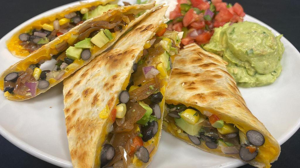 Roasted Corn & Black Bean · made with cheddar and monterey jack, loaded with caramelized onions and sliced avocado