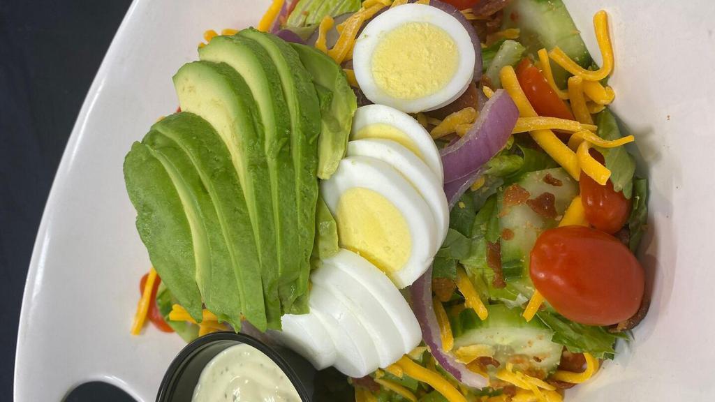 Avocado Club · lettuce, tomato, cucumber, red onion, sliced avocado, crispy bacon bits, hard-boiled egg, and shredded cheddar served with our avocado-ranch dressing on the side