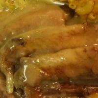 Turkey Wings  · Baked turkey wings over rice with or without gravy. Comes with 2 sides and cornbread .