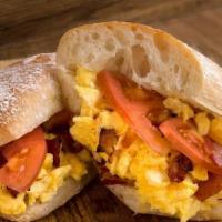 Ultimate Breakfast Sandwich · Two Farm Fresh Scrambled Eggs, Savory Bacon, Tomato and Melted Aged White Cheddar Cheese - C...