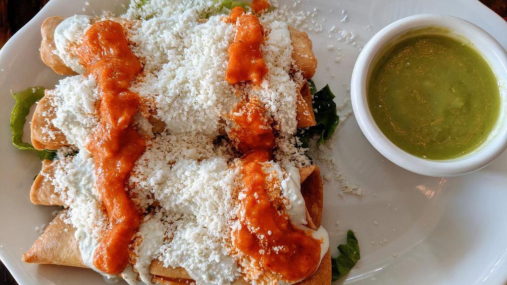 Cheese Flautitas · Crispy taquitos, stuffed with cheese topped with cotija cheese, salsa de árbol, served with avocado crema.