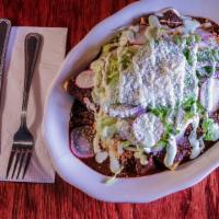 Mole Enchiladas · Corn tortillas stuffed with cheese, topped with homemade mole poblano, lettuce, radishes, re...