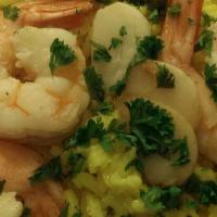 Shrimp Scampi · Garlic sauce and rice.