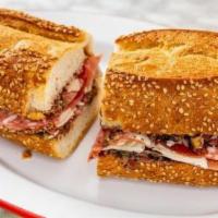 Muffaletta · Prosciutto, capicola, salami, shaved Parmesan, and housemade olive salad on a seeded caputo'...