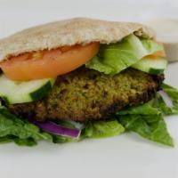 Falafel Sandwich (Regular) · Baked falafel, hummus, lettuce. Tomato, cucumber and onions in a wheat pita.