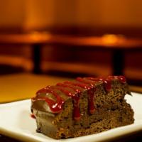 Chocolate Decadence · Home made chocolate fudge on top with strawberry drizzle.