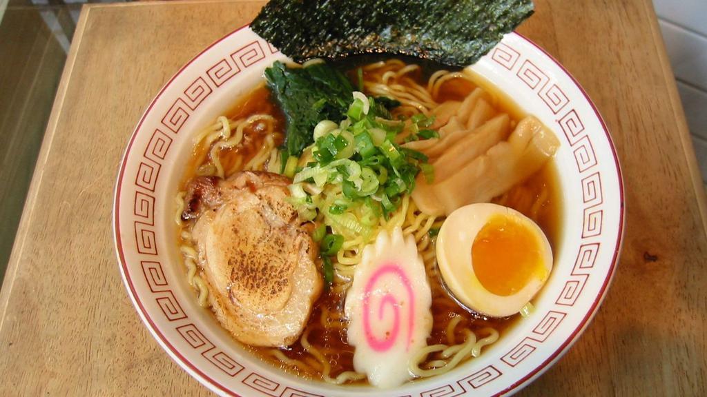 Shoyu Ramen · Classic, soy sauce flavored chicken broth enhanced with umami. Served with wavy noodles, roasted pork, egg, bamboo shoot, fish cake, scallions and seaweed.
