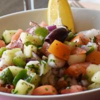 Shepherd Salad  · Finely chopped tomatoes, cucumbers, green peppers, red onions, and parsley, tossed with oliv...
