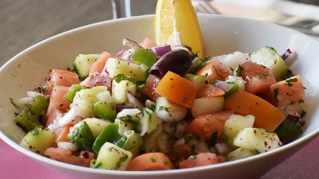 Shepherd Salad  · Finely chopped tomatoes, cucumbers, green peppers, red onions, and parsley, tossed with olive oil, red vinegar, and lemon juice.