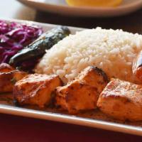 Chicken Shish Kebab · Skewered cubes of marinated char-grilled chicken served  with rice a red cabbage, onion sala...