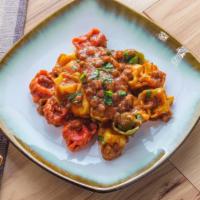 Tomato Pesto Tri-Color Pasta · Chef's classic tomato pesto sauce mixed with slowly cooked tri-color pasta.