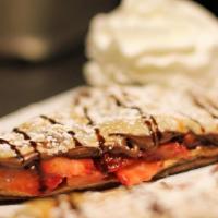 Chocolate Cover Crepe · Nutella and strawberries. Sweet crepes are not served with syrup or whipped cream on top.