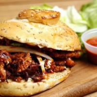Spicy Pork Cemita · Fresh handmade Mexican bread with sesame seeds, topped with mayo and filled with quesillo (M...