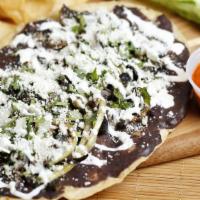 Mushroom Huarache · Handmade corn tortilla topped with refried beans, onions, lettuce, cilantro, cotija cheese a...