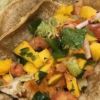 Grilled Fish Taco · Grilled fish served on a corn tortilla with lettuce, our fresh made mango salsa and chipotle...