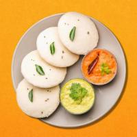 Lentil-Rice Cake   · Three steamed savory rice cakes served with a lentil soup, a tangy tomato, and classic cocon...