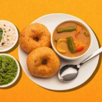 Crispy Dip Fritter · Deep-fried savory doughnuts served with a lentil soup, a tangy tomato, and a classic coconut...