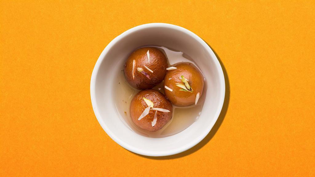 Gulab Jamun · Softballs made of reduced milk, flour, and a leavening agent, dipped in syrup and served warm.