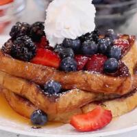 The Ultimate French Toast · Topped with 4 Berries & Whip Cream. Served w/ Butter & Maple Syrup.
