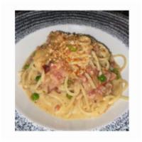 Spaghetti Carbonara · Hand-cut spaghetti with guanciale, pancetta, caramelized onion, roasted garlic, English peas...