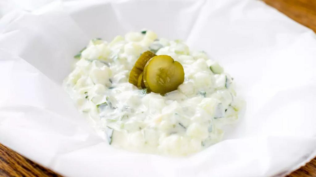 Tzatziki · Fresh diced cucumber mixed in organic yogurt with fresh mint leaves, dill and a hint of olive oil.