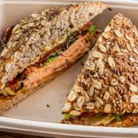 The Atlantic · Atlantic salmon, sliced vine-ripened tomato marinated with olive oil and basil and hummus on...