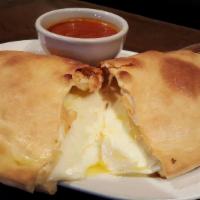 Cheese Calzone · Mozzarella and ricotta cheese inside of a perfect calzone crust - side of sauce