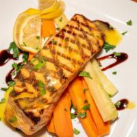 Salmon Cartoccia · Oven baked fresh salmon with fresh julienne vegetables served in a white wine lemon sauce.