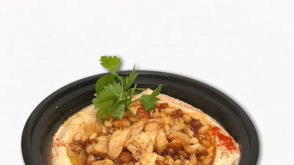  - Hummus Bi Djaj · Hummus topped with marinated chicken and pine nuts.