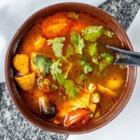 Tom Yum Soup · Spicy. Savory sour soup with mushrooms, lemongrass, lime leaves, tomatoes, and chilis.