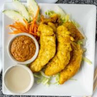 Chicken Satay · With peanut sauce and cucumber sauce.