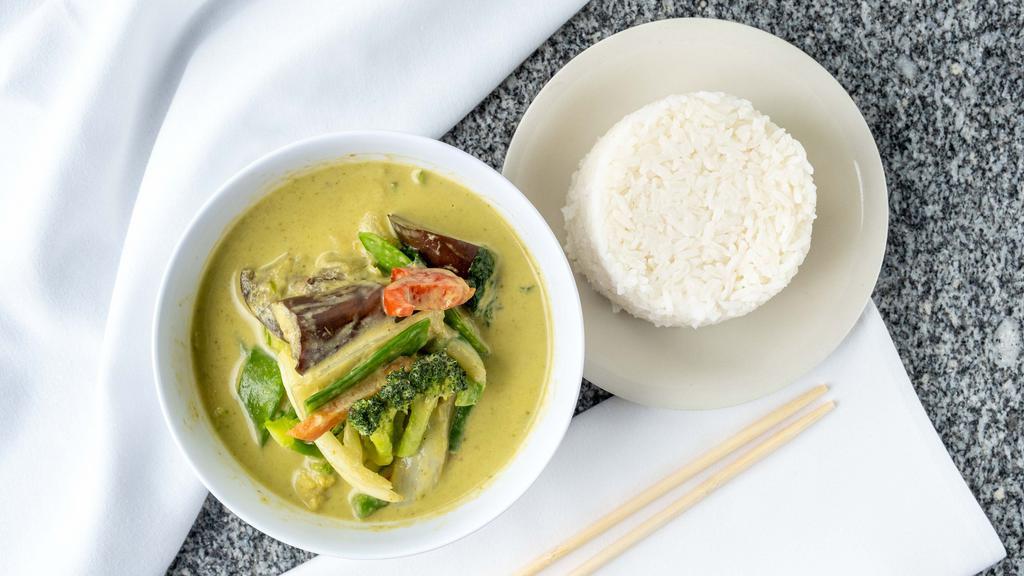 Green Curry · Spicy. Served with jasmine rice. Green curry paste, coconut, bell peppers, zucchinis, eggplants, bell peppers, basil, and bamboo shoots.