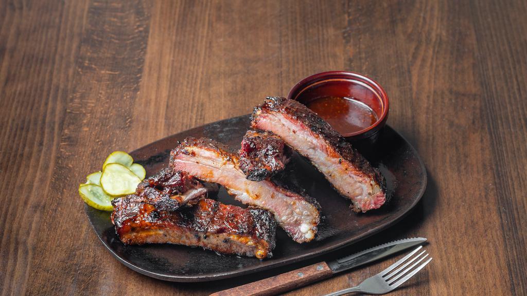 Spare Ribs · Dry rubbed and slow smoked St Louis cut spareribs finished on the grilled with our Sweet and Smokey BBQ Sauce.