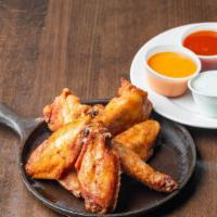 Smoked Wings · Slow smoked and flash-fried jumbo party wings tossed in your choice of sauce.