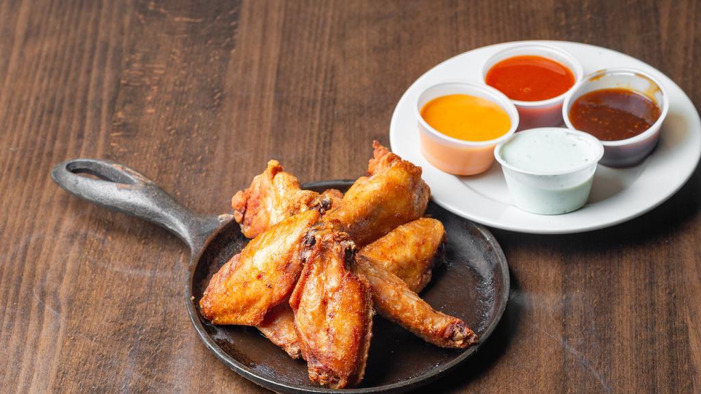 Smoked Wings · Slow smoked and flash-fried jumbo party wings tossed in your choice of sauce.