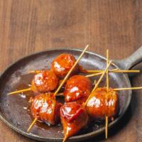 Texas Lollipops · Smoked Bratwurst wrapped in bacon on a stick, dipped in Sweet and Smokey BBQ Sauce and serve...